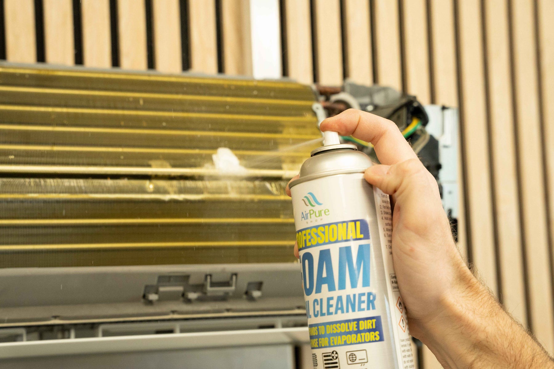 Applying foaming coil cleaner to an HVAC evaporator coil for professional maintenance